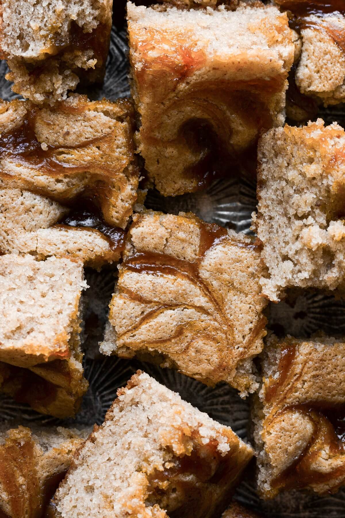 Pecan cake swirled with pumpkin butter, cut into squares.