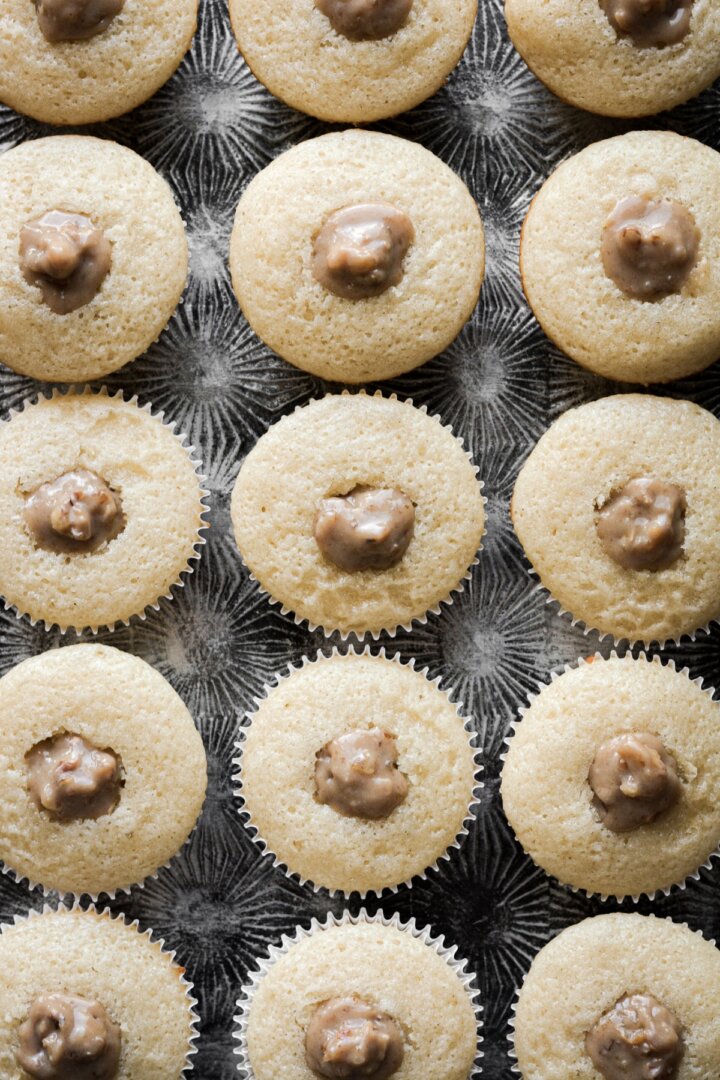 Vanilla cupcakes with pecan pie filling.