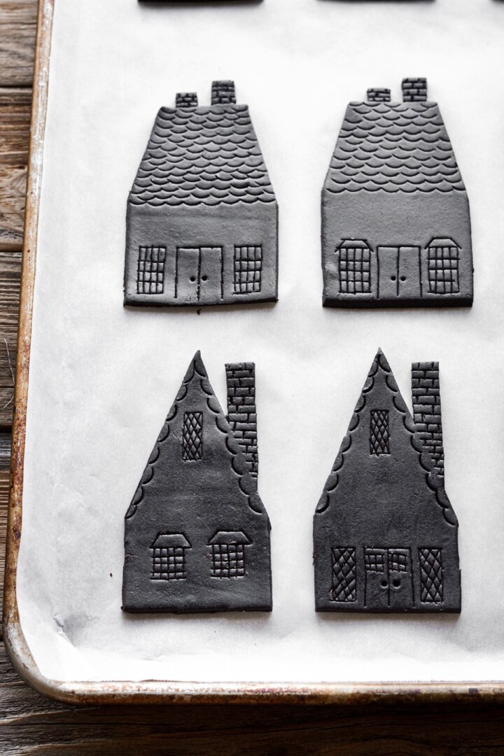 Chocolate cookie houses embossed with decorations.
