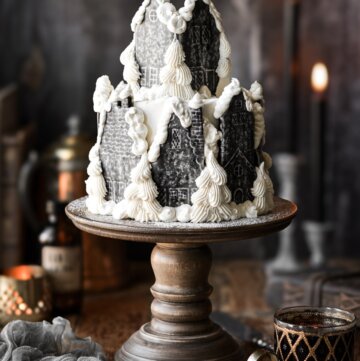 Hogsmeade village cake on a wooden cake stand.