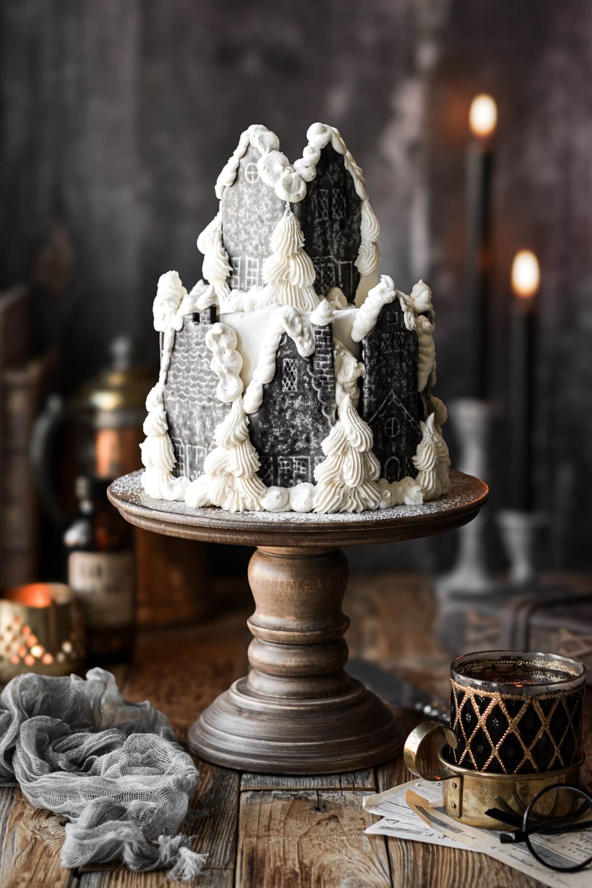 Hogsmeade village cake on a wooden cake stand.