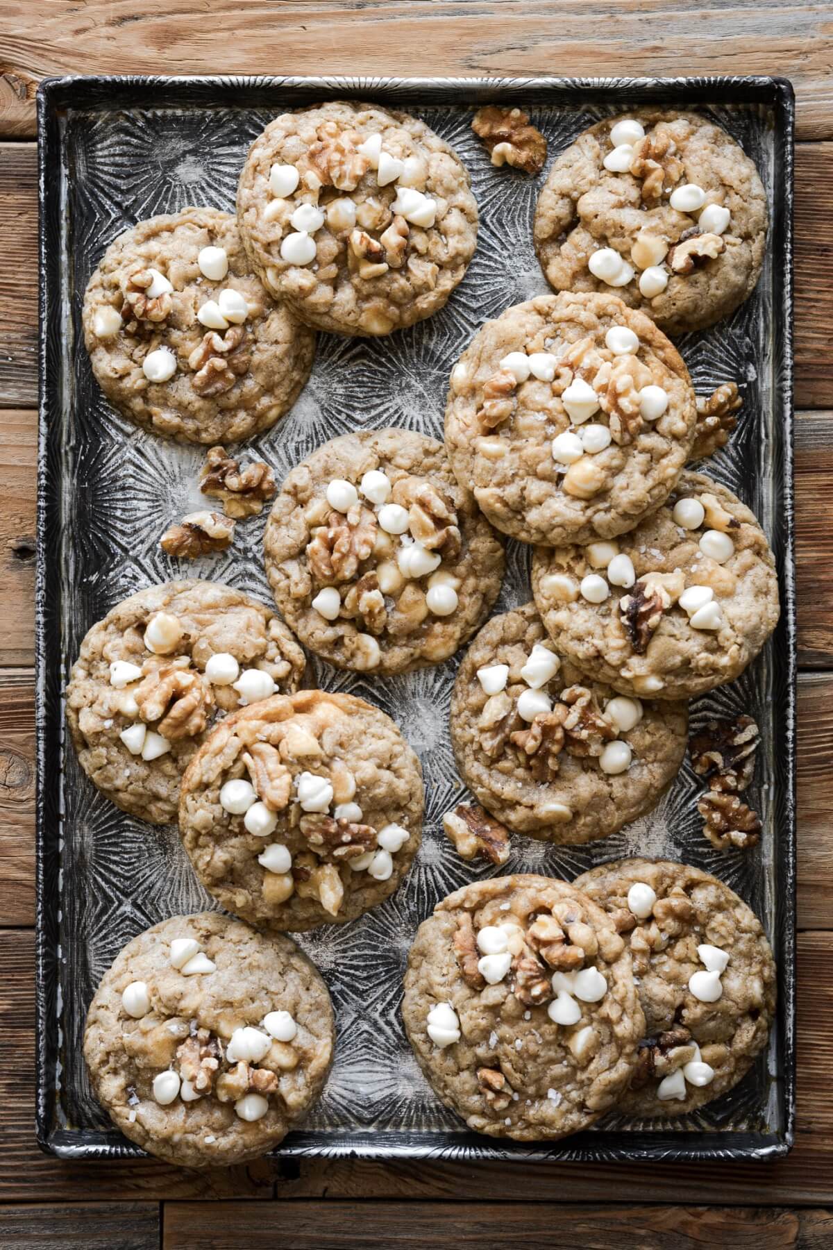 Maple walnut white chocolate chip oatmeal cookies on a baking sheet.
