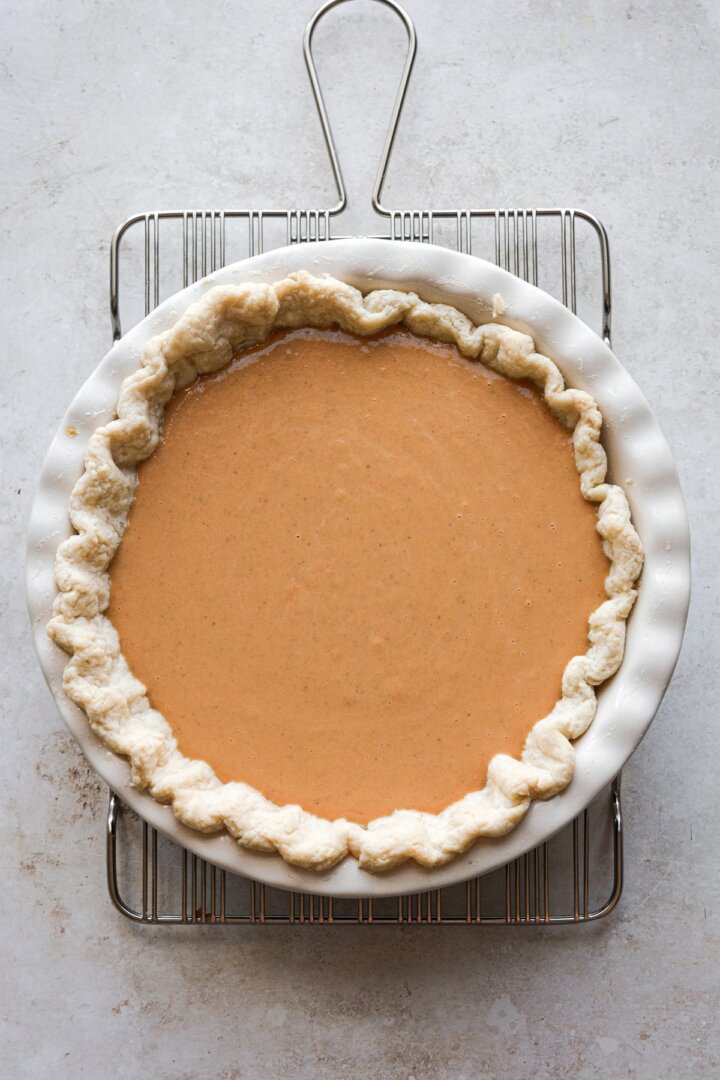 Pumpkin pie filling in pie crust.