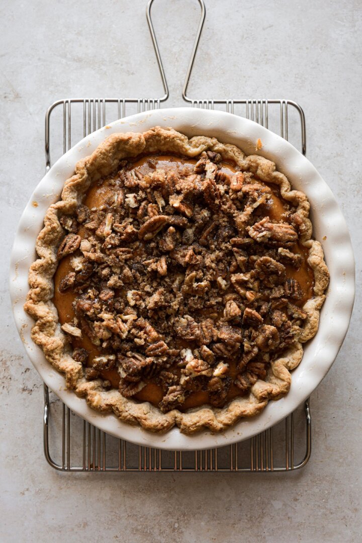 Pumpkin pie topped with pecans.