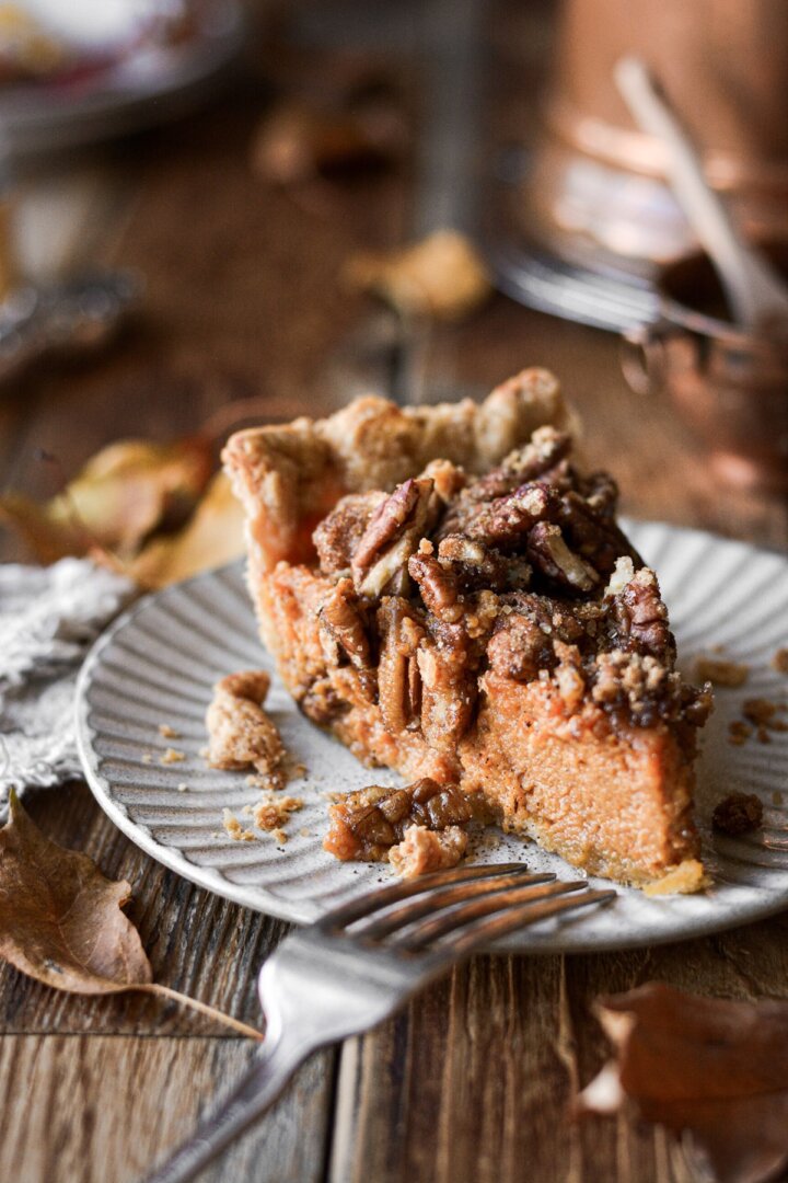 A slice of pecan pie topped with pecans.