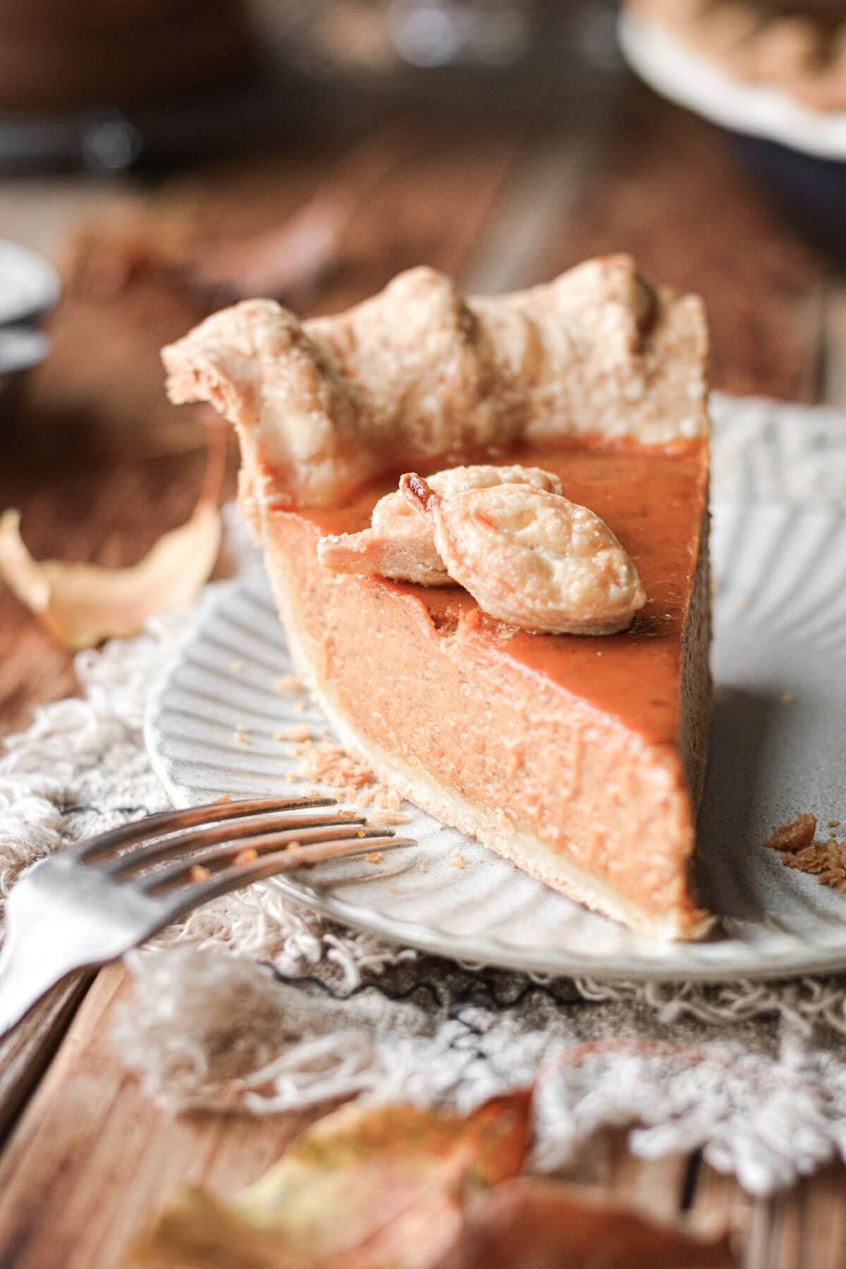 A slice of pumpkin pie on a plate.