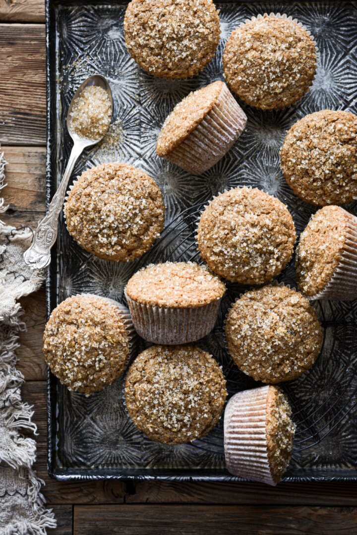 Gingerbread muffins with lemon sugar arranged on a baking sheet.