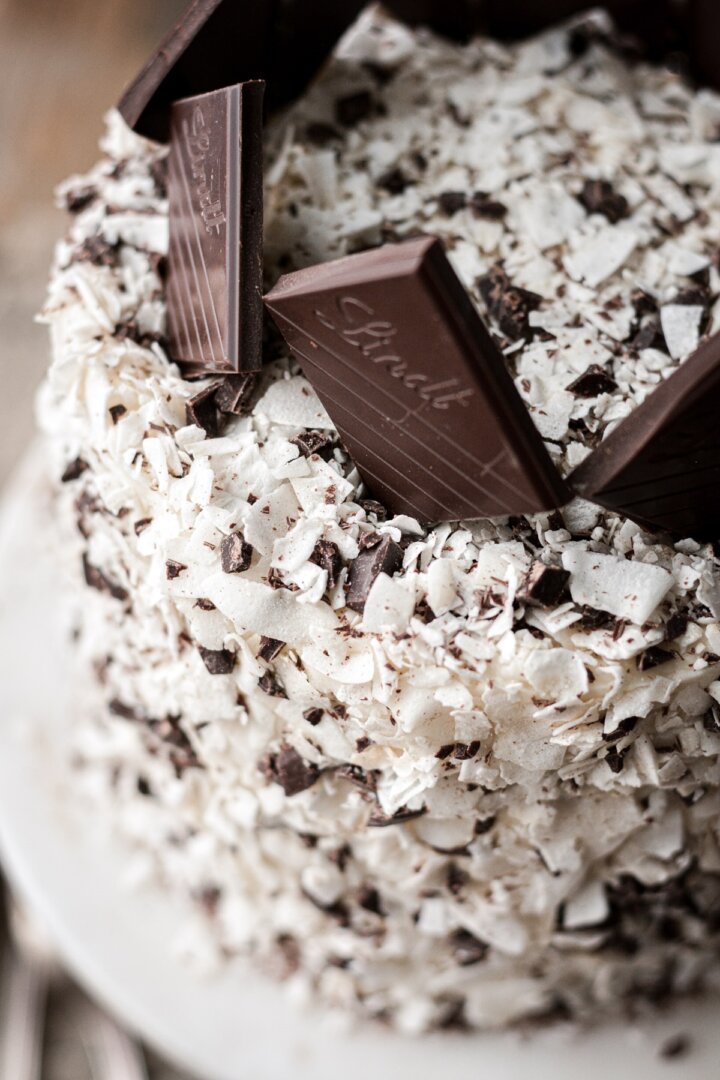 Chocolate squares on top of a coconut cake.