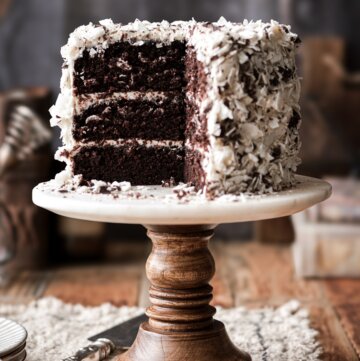 Chocolate coconut cake with a slice cut.