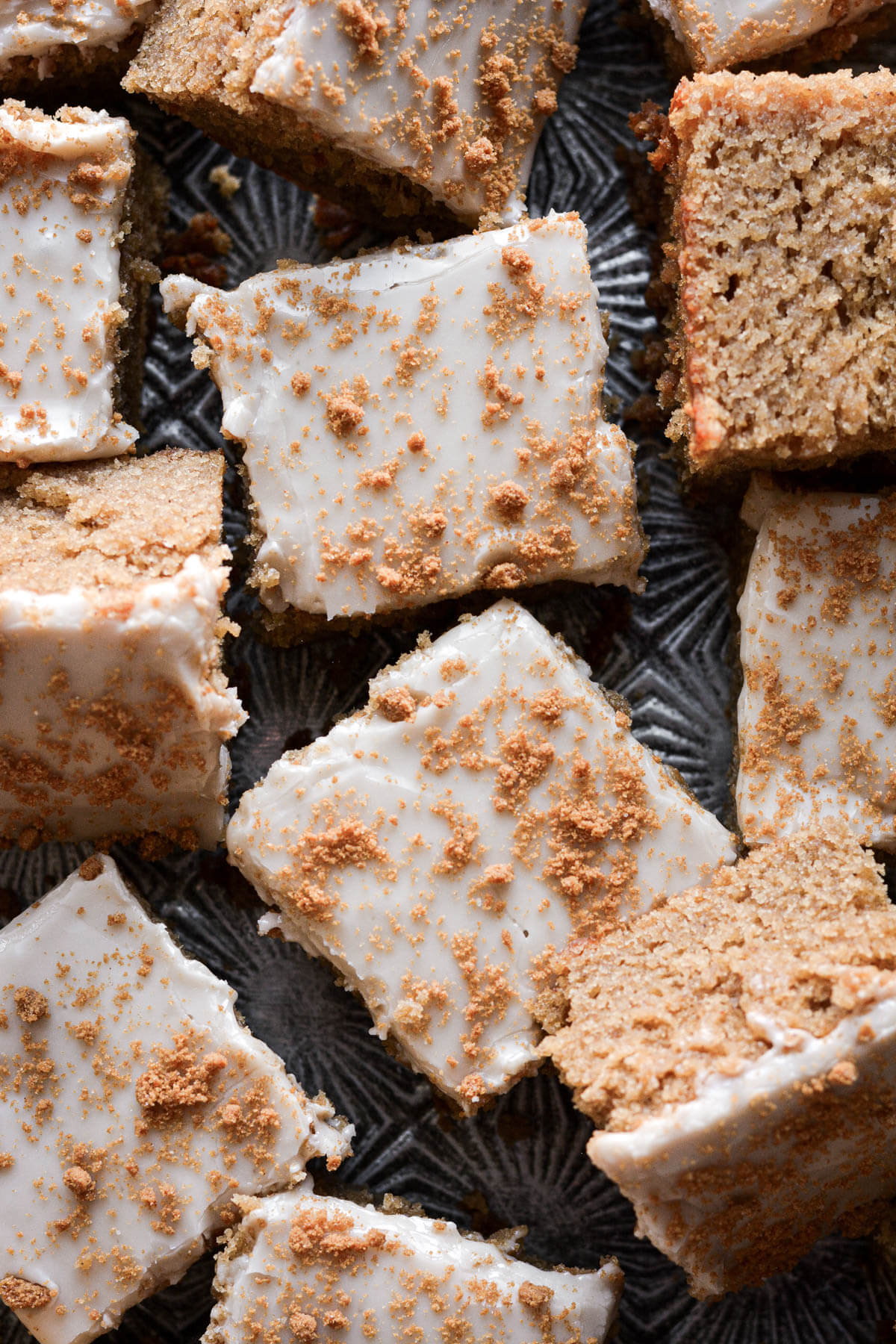 Gingerbread bars with maple icing and crumbled biscoff cookies.