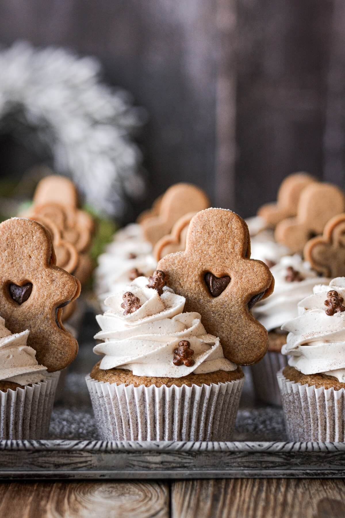 Gingerbread cupcakes topped with gingerbread cookies.