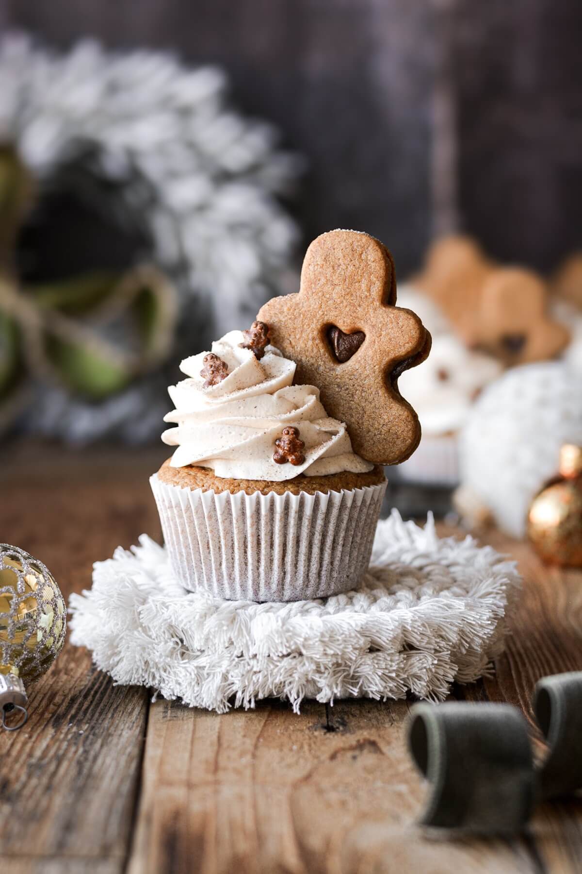 Gingerbread cupcake topped with a gingerbread cookie.