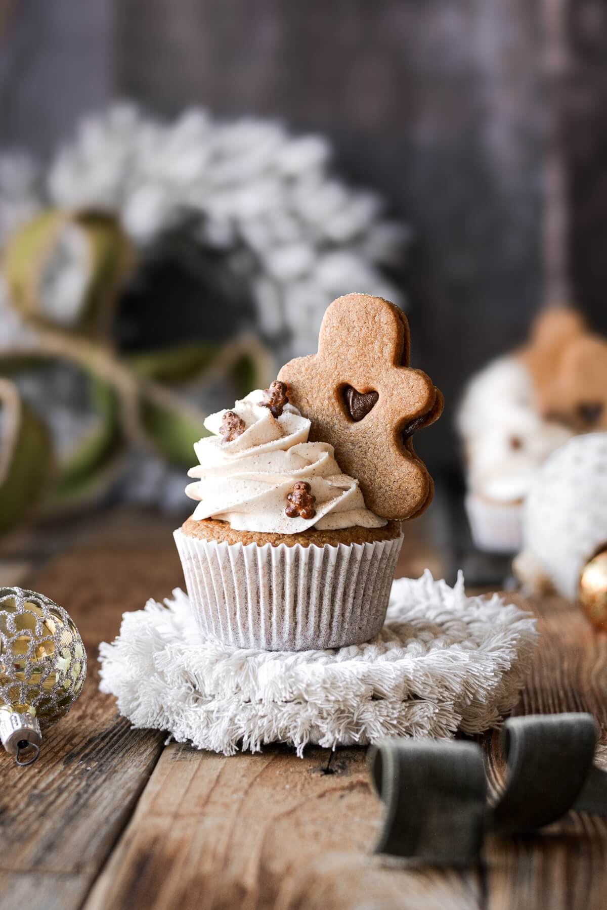 Gingerbread cupcake topped with a gingerbread cookie.