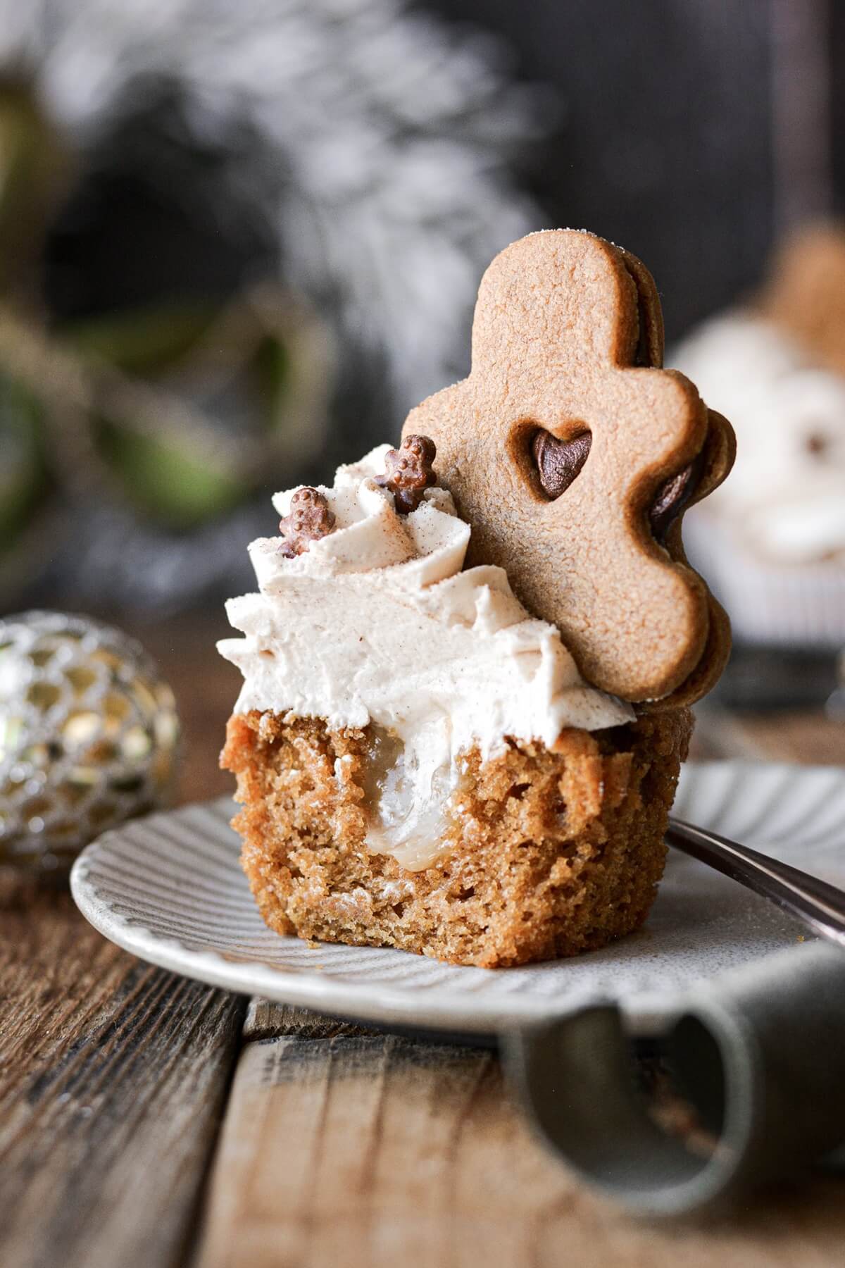 Gingerbread cupcake with lemon curd filling and a cookie on top.
