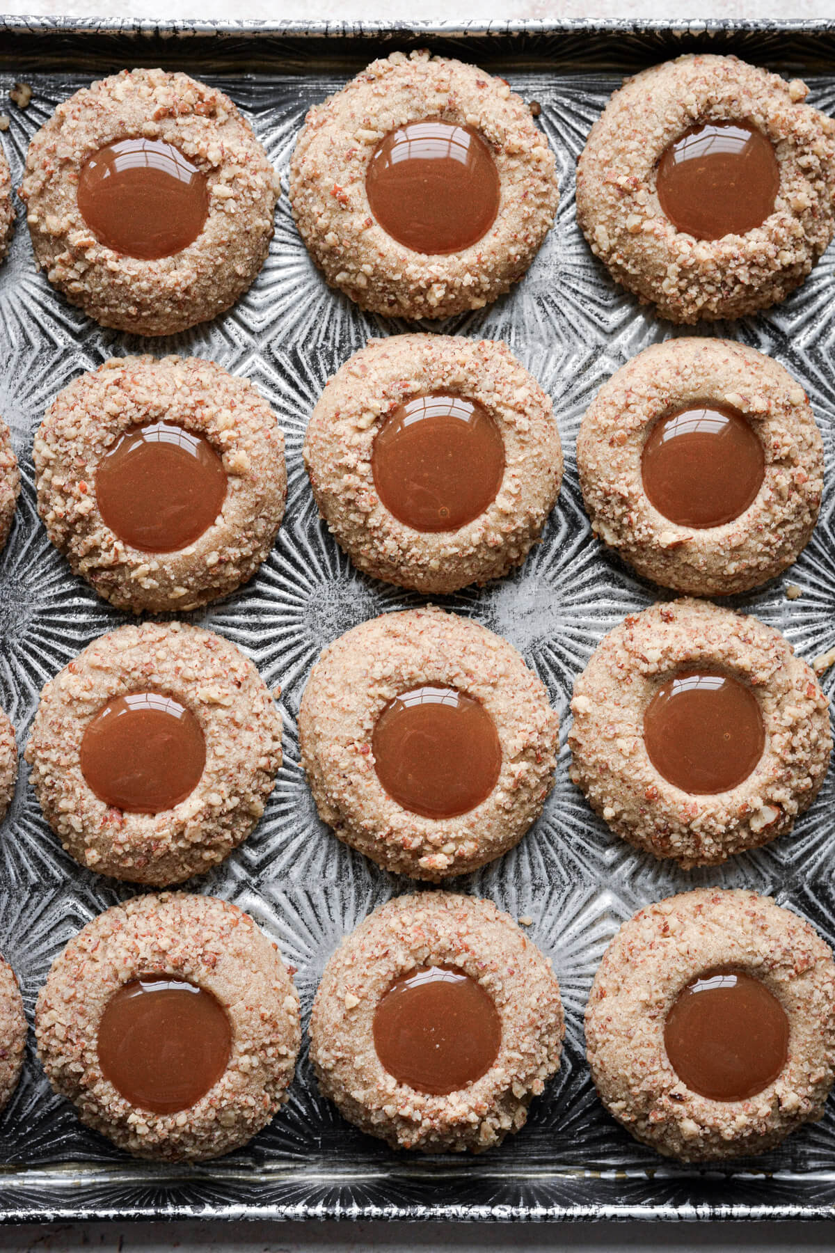 Gingerbread pecan caramel thumbprint cookies.
