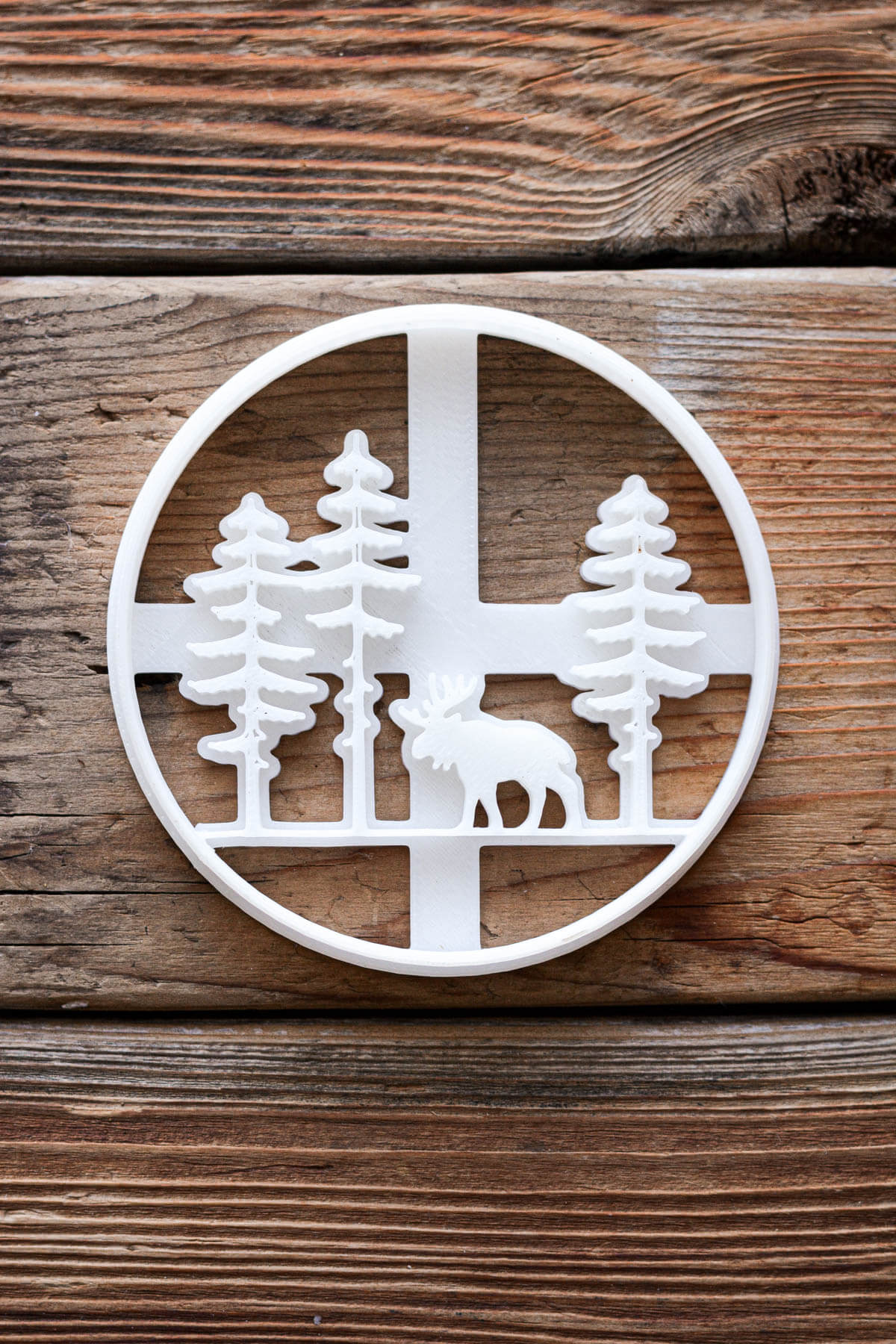 Cookie cutter with trees and moose stamps.
