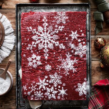 Red velvet sheet cake with powdered sugar snowflakes.