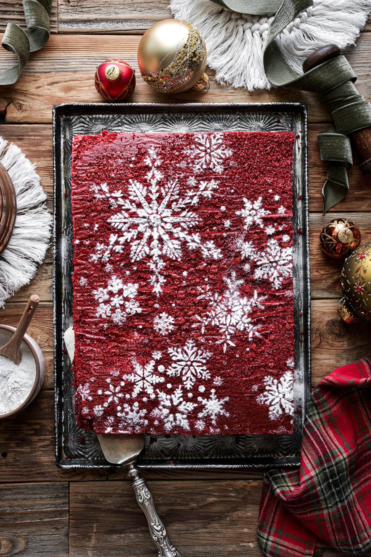 Red velvet sheet cake with powdered sugar snowflakes.