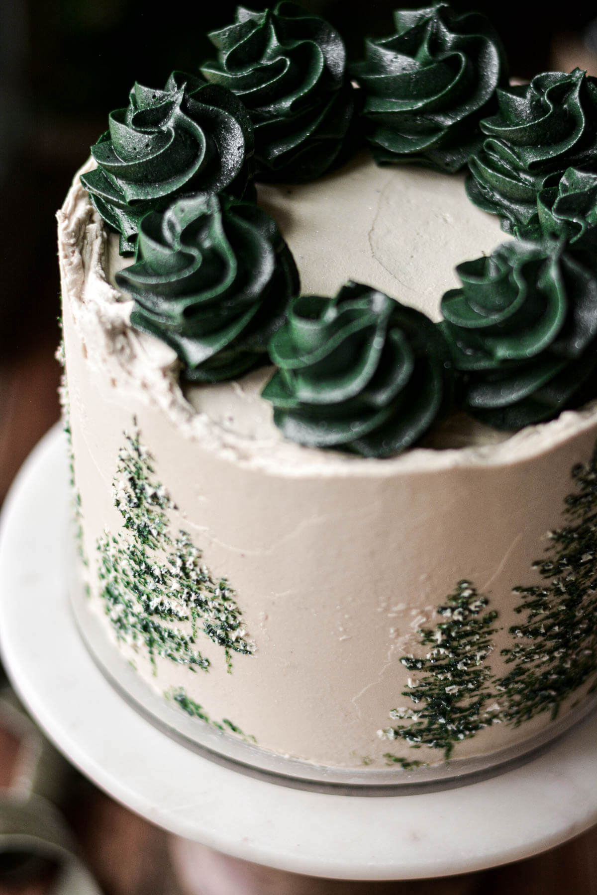 Green buttercream swirls on top of a cake.