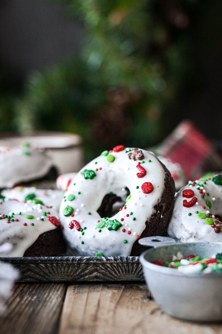Chocolate peppermint donut with Christmas sprinkles and vanilla icing.