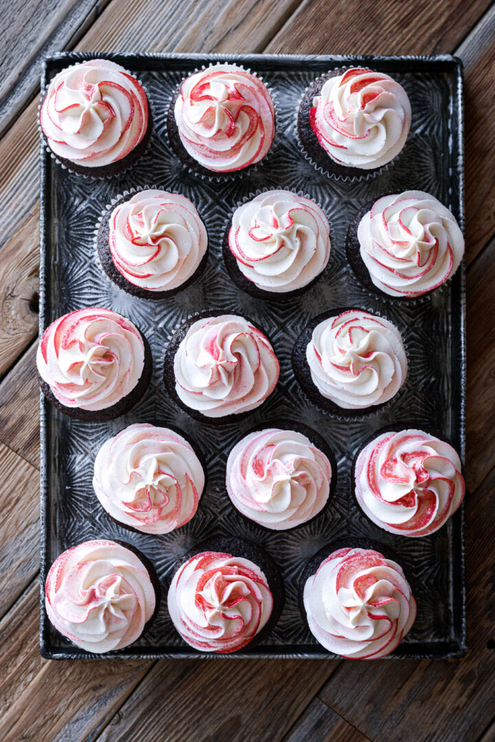 Red and white swirled peppermint frosting on chocolate cupcakes.