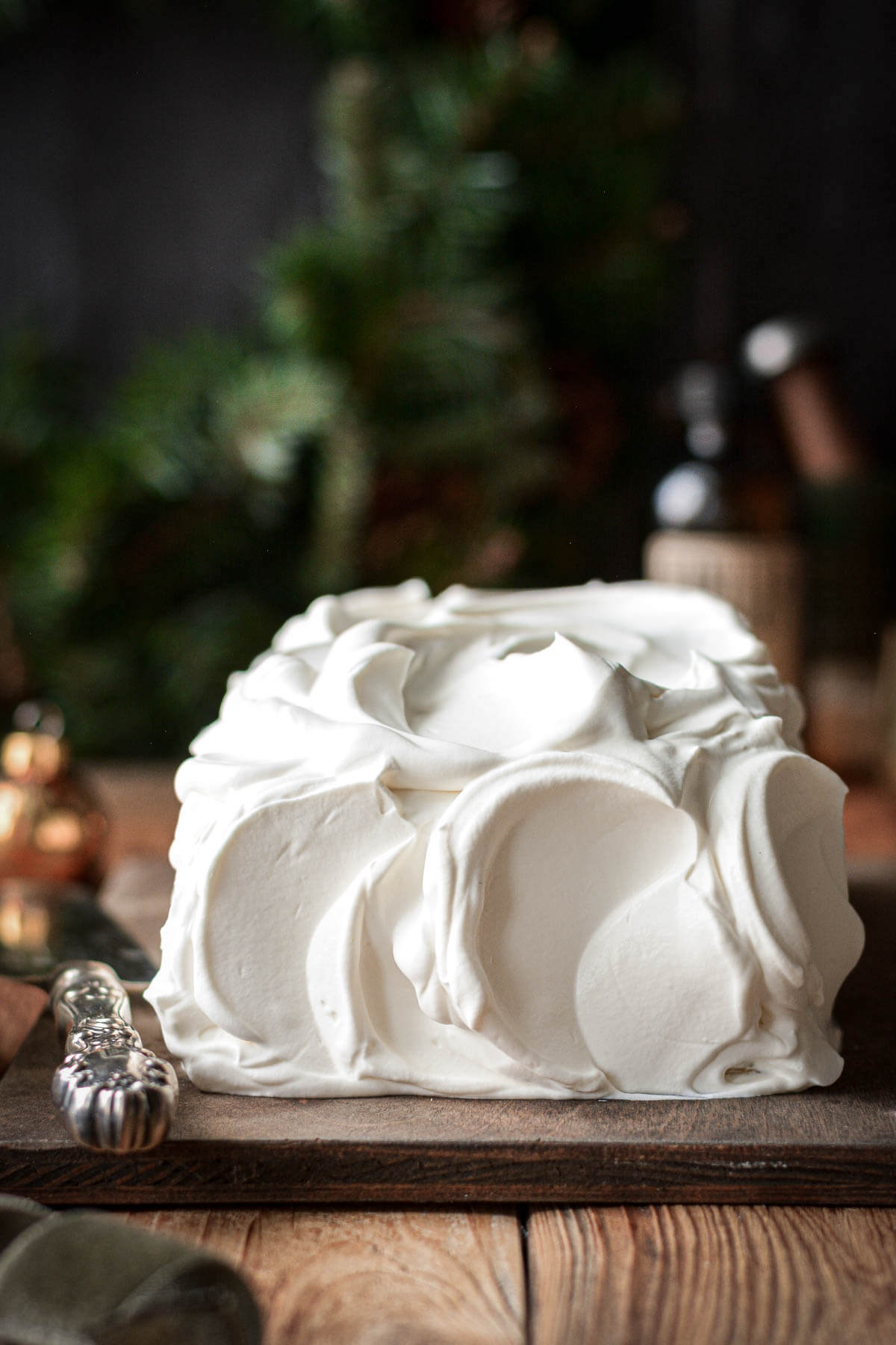 Whipped cream covering an eggnog icebox cake.