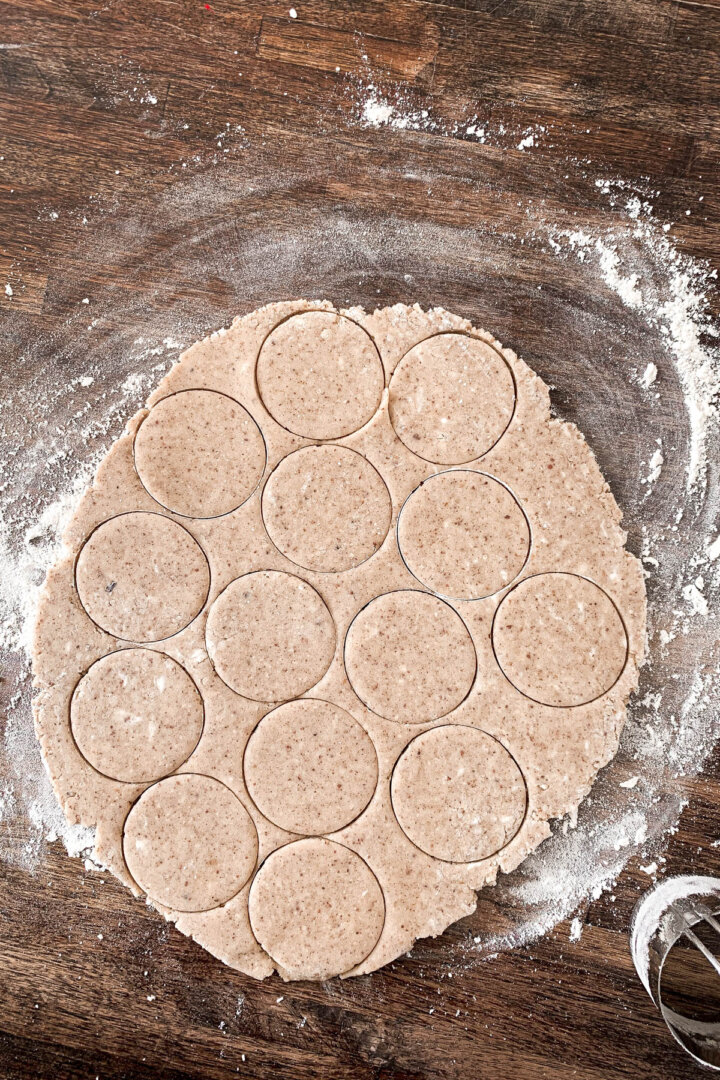 Pecan shortbread dough rolled out and cut in circles.