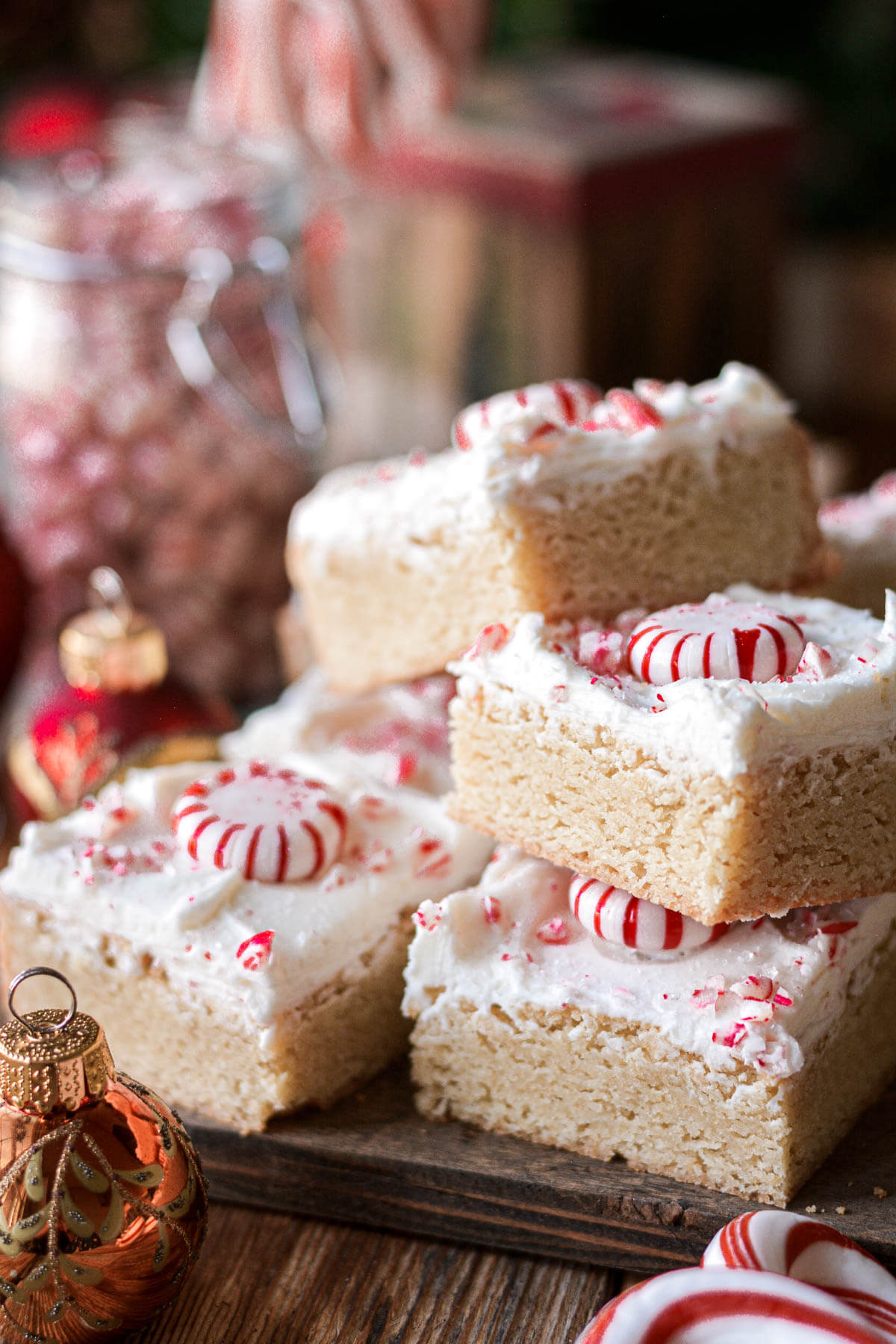 Stack of peppermint blondies with frosting and peppermint candy.