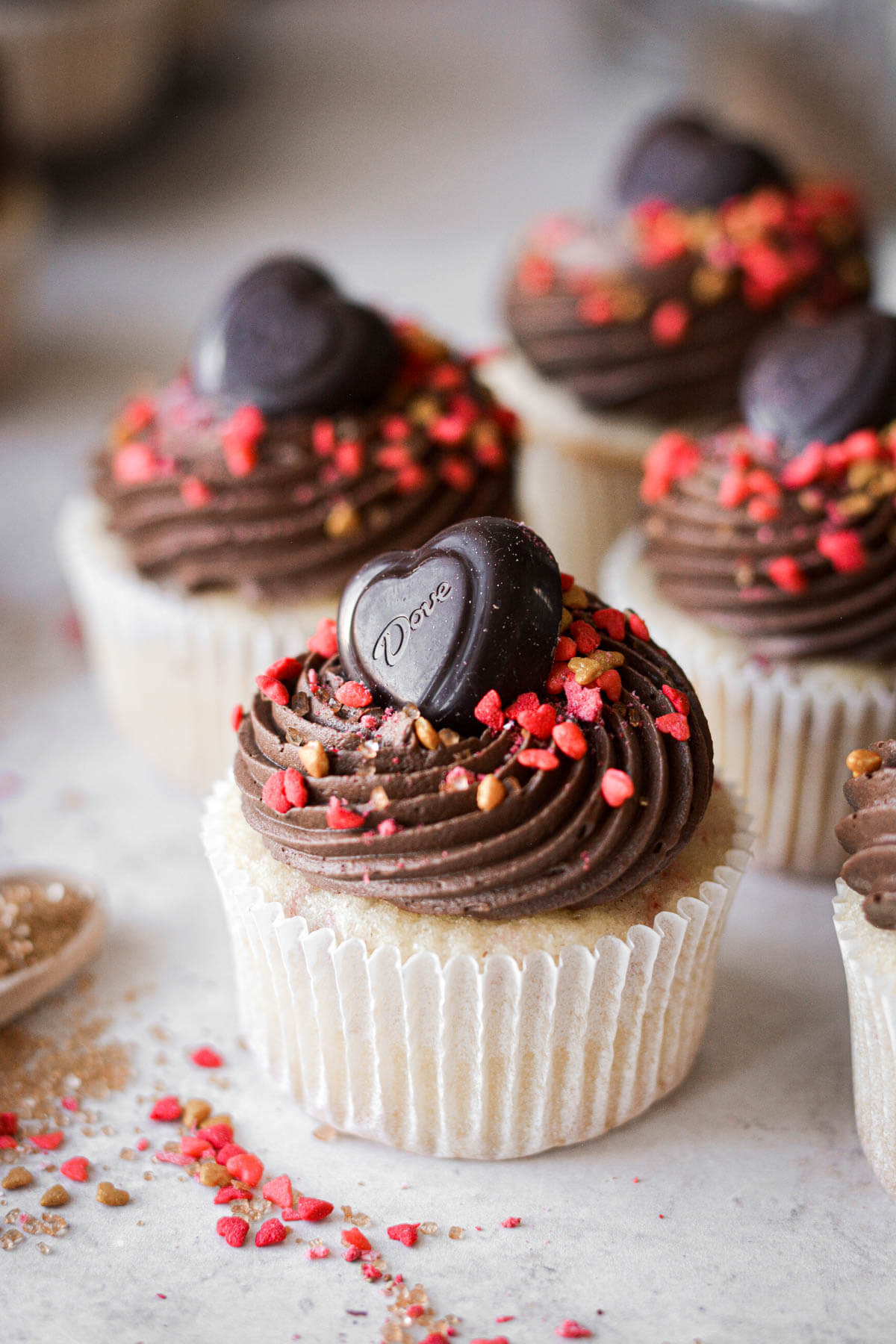 Chocolate hearts and valentines sprinkles on strawberry chocolate cupcakes.