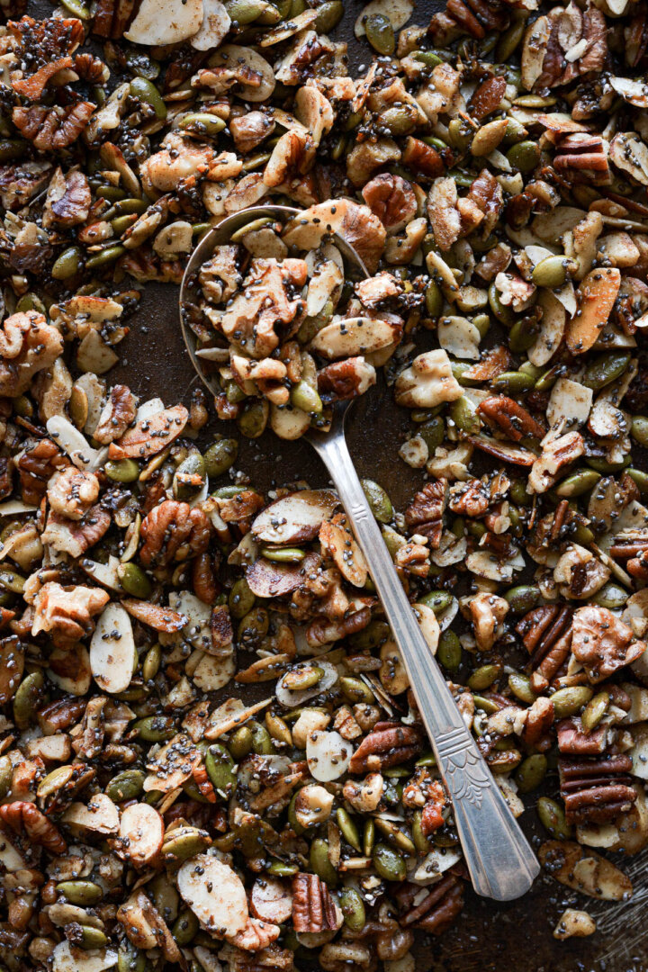 Spoonful of maple vanilla almond grain free granola with assorted nuts and seeds.