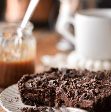 Mini chocolate ganache tart with two forks.