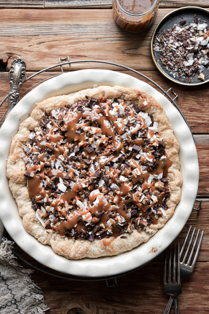 German chocolate pie, topped with coconut, pecans, chopped chocolate and caramel sauce.