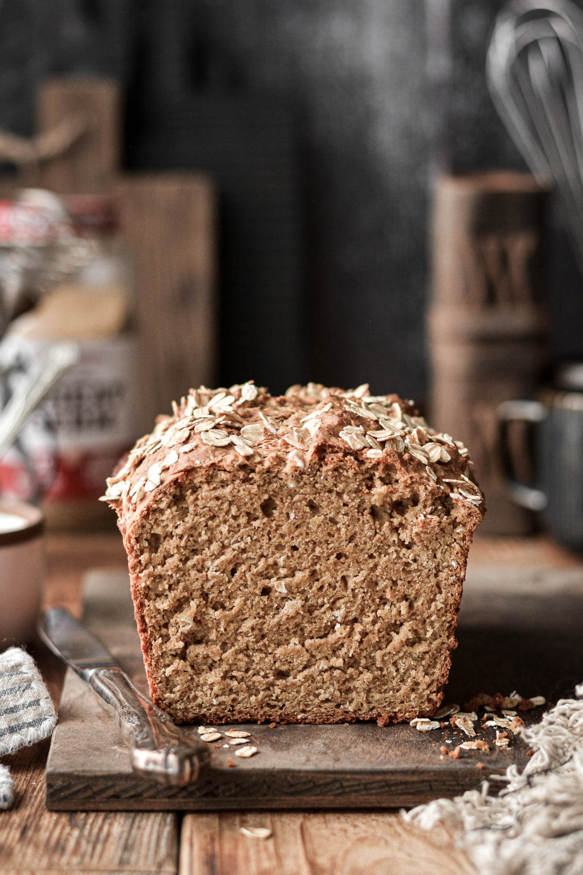 A loaf of Irish brown bread on a wooden cutting board.