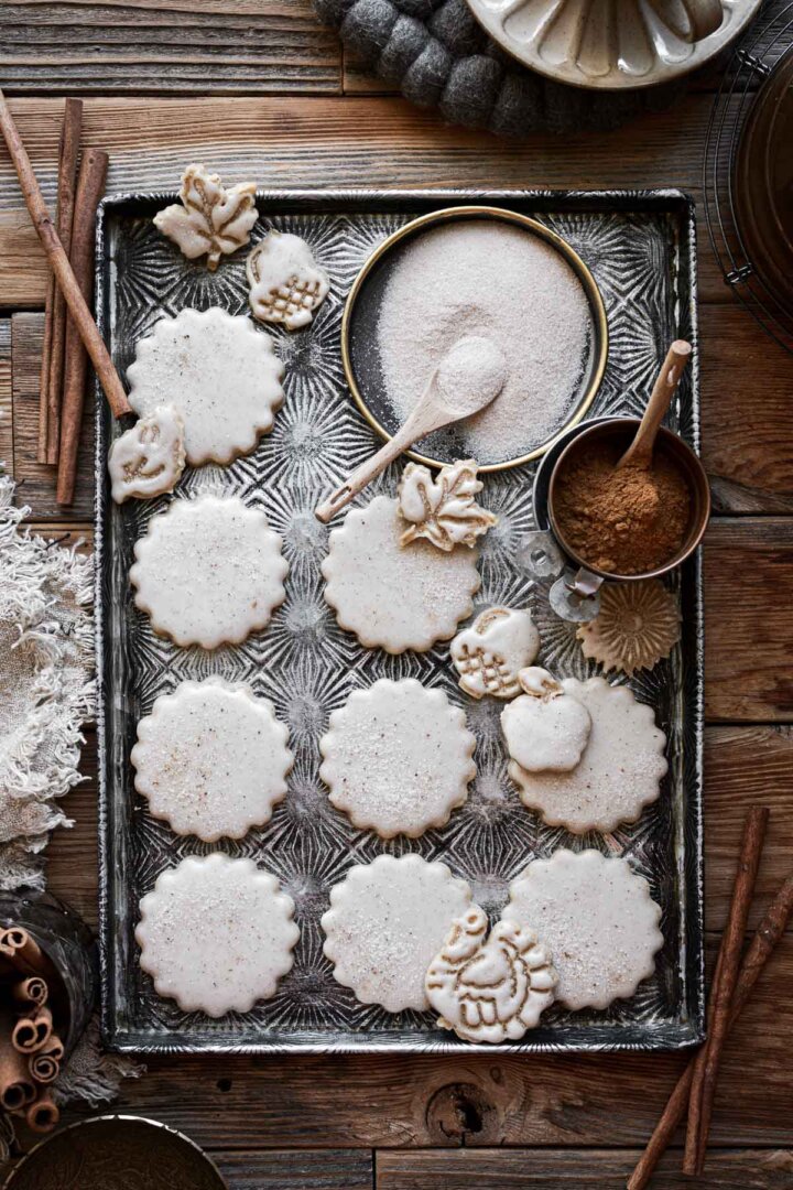 Iced chai spice cookies on a baking sheet with cinnamon sugar.