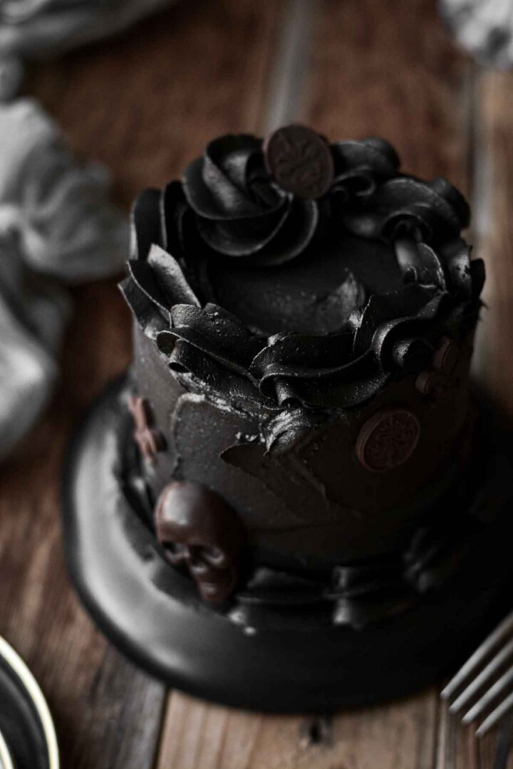 Mini black velvet cake with chocolate Halloween decorations.