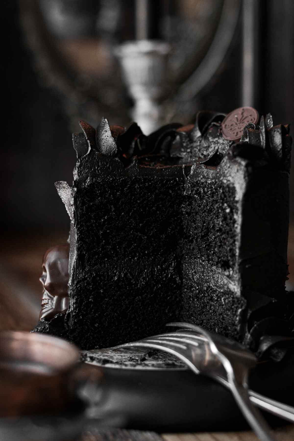 Black velvet cake with a slice cut.