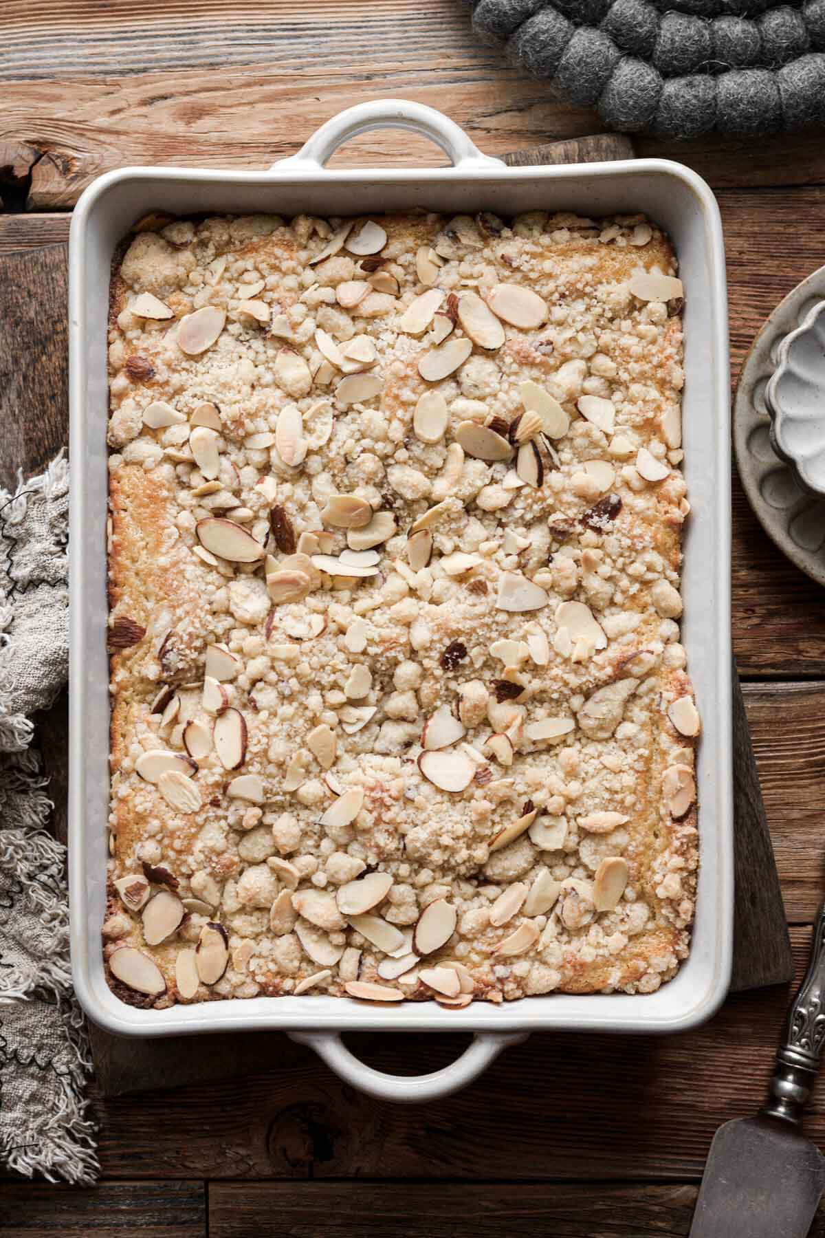 Almond coffee cake with crumb topping in a baking dish.