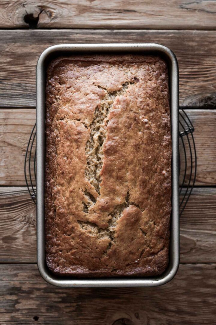 Loaf of banana bread in a loaf pan.