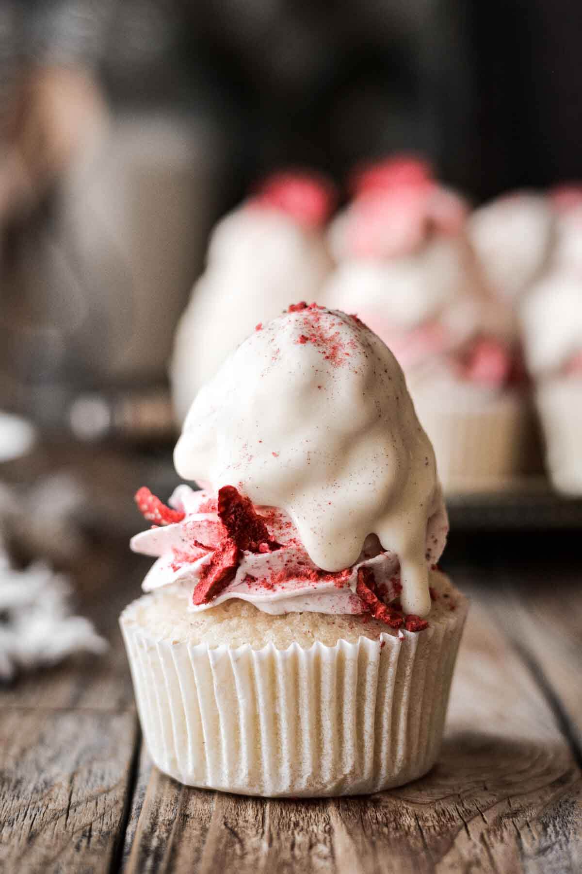 Vanilla strawberry cupcake dipped in white chocolate.