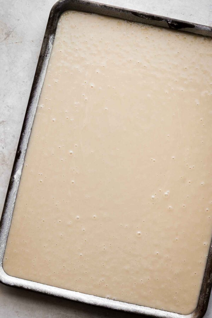 Step 7 for making white Texas sheet cake.