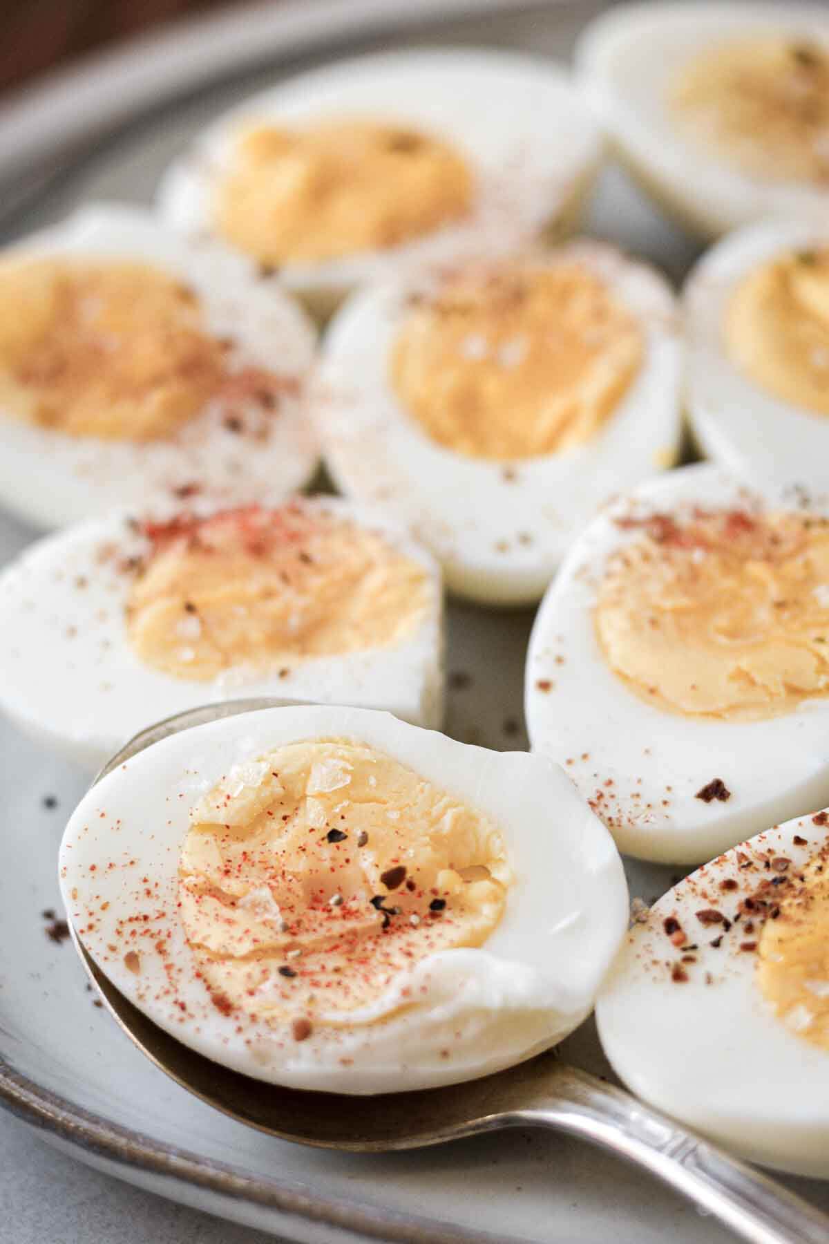 Hard boiled eggs cut in half and sprinkled with salt, pepper and paprika.