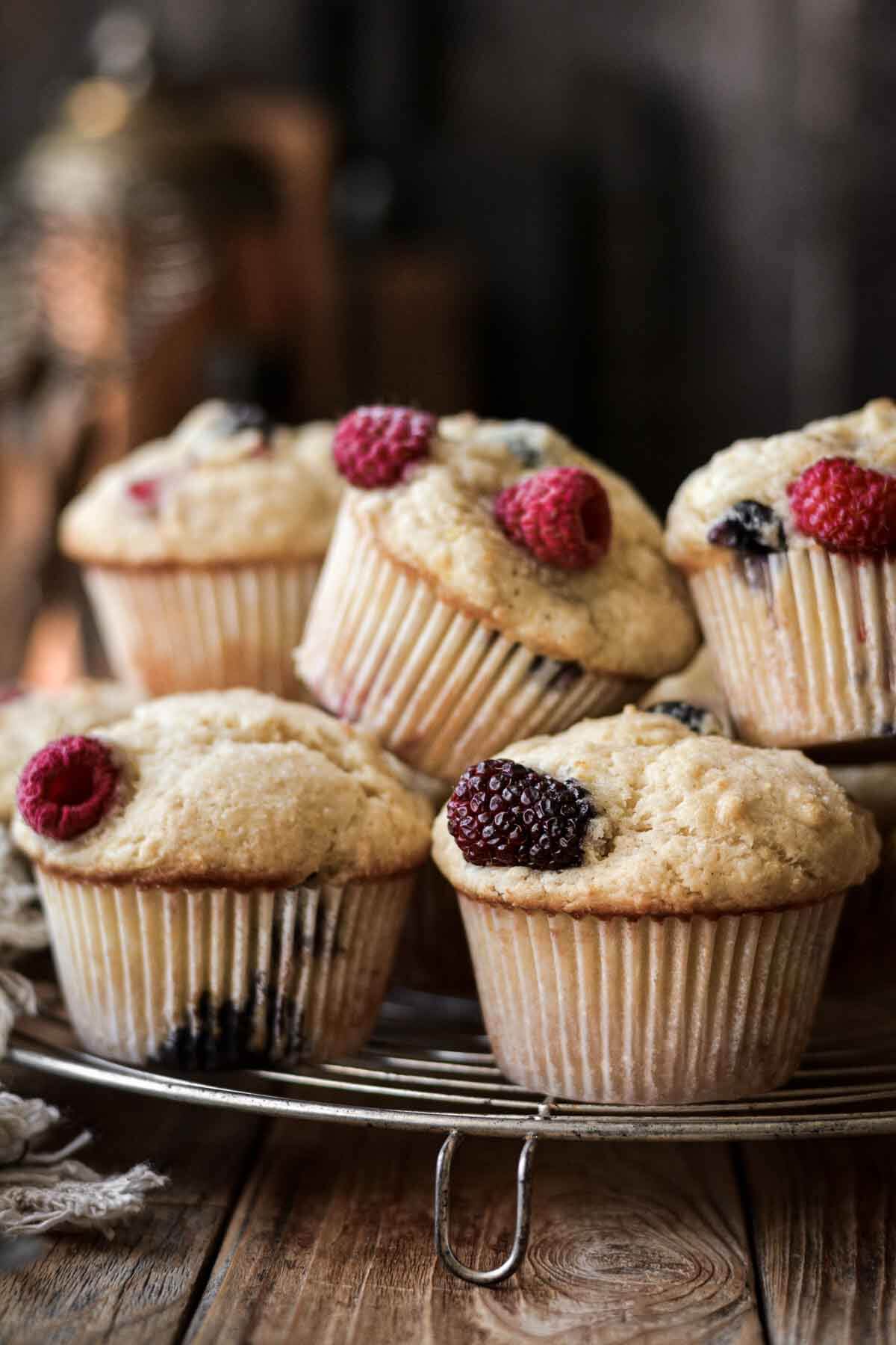 Mixed berry muffins on a cooling rack.