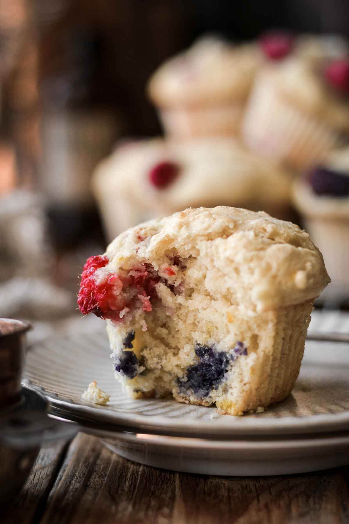 Berry muffin with a bite taken.