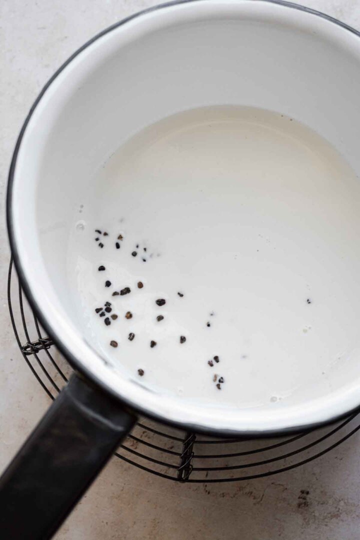Cardamom seeds steeping in milk.