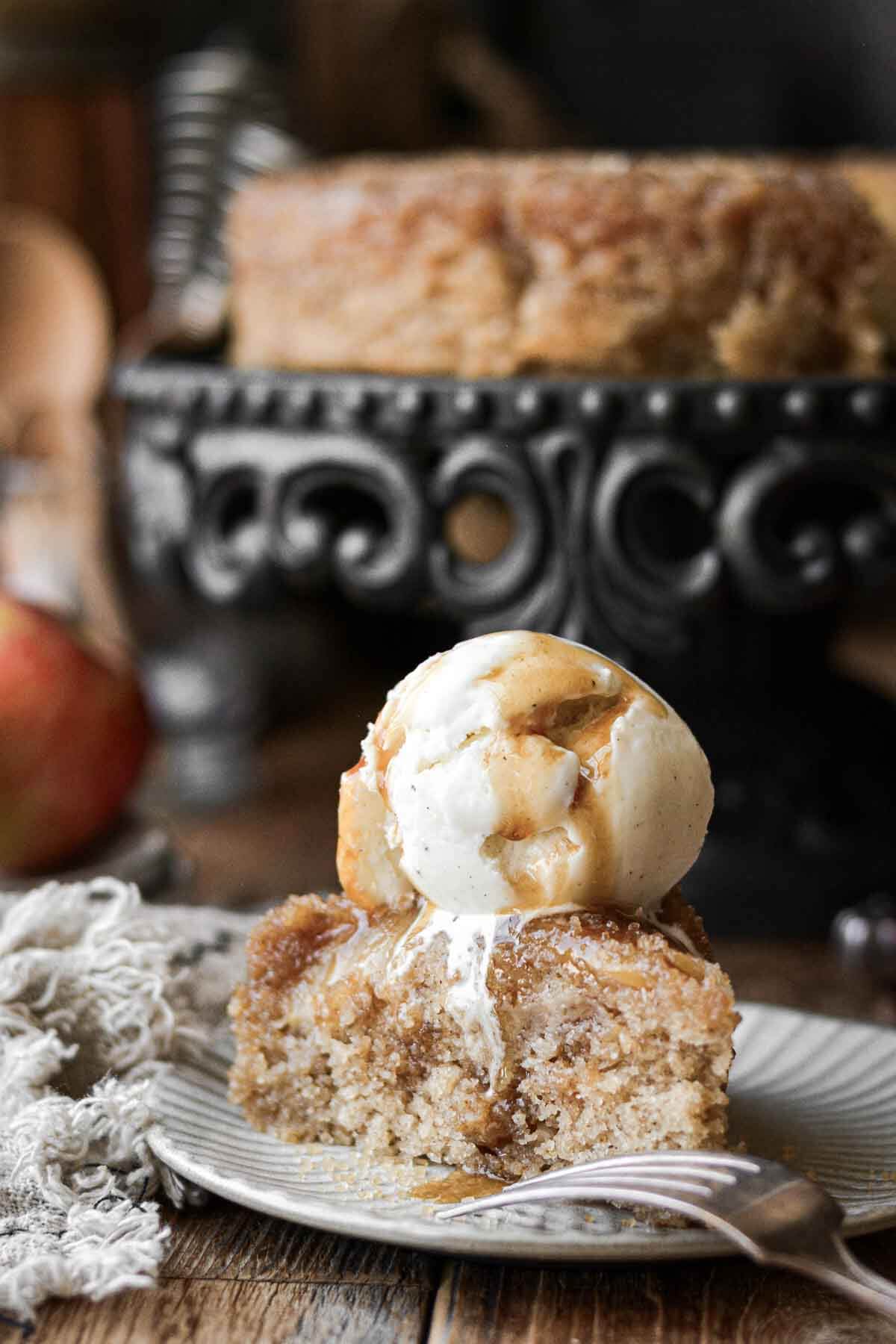 Apple upside down cake with a scoop of melting ice cream.