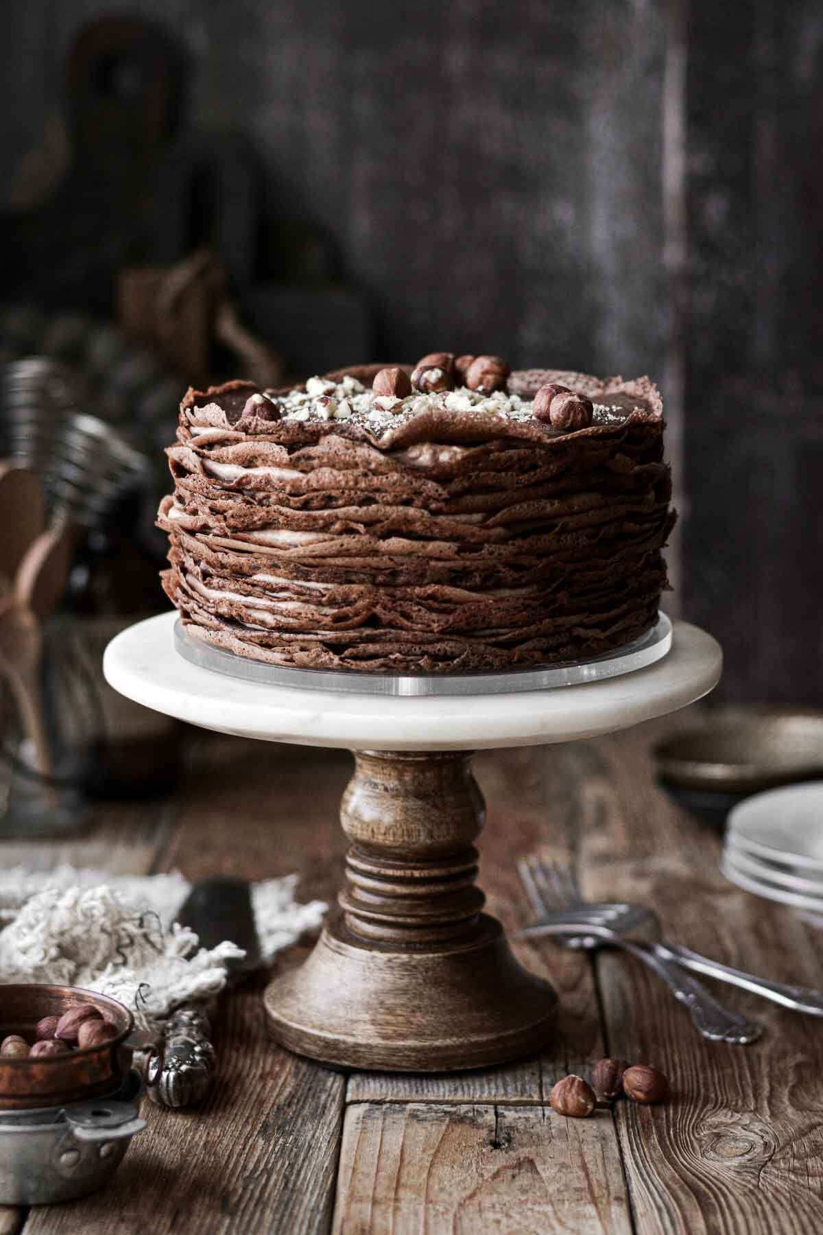 Chocolate crepe cake on a cake stand.