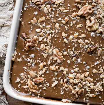 Penuche frosting and walnuts on a maple cake.