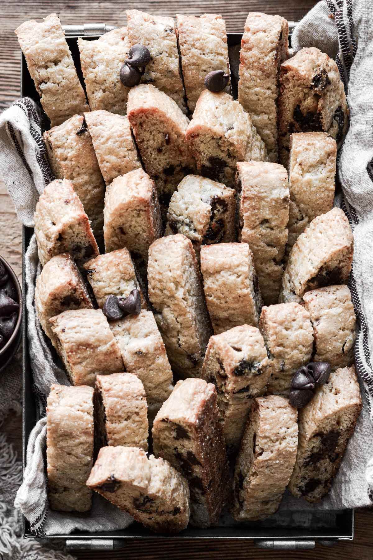 Cherry chocolate chip biscotti stacked in a pan.