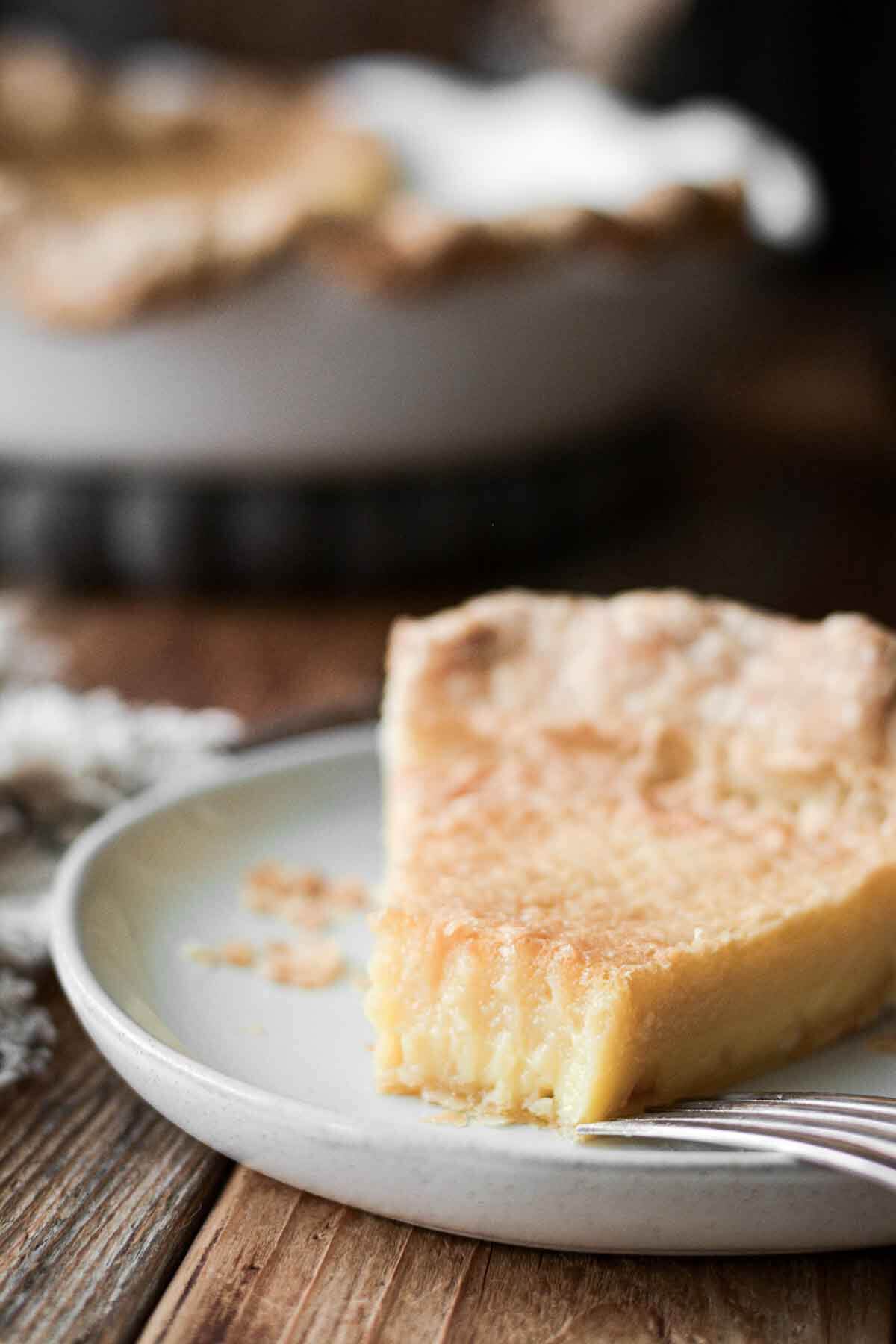 Slice of chess pie with a bite taken.