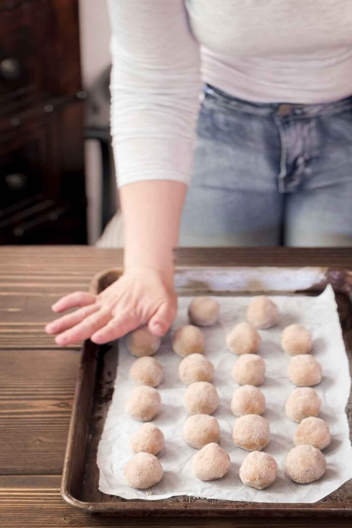 Step 4 for making maple cookies - flattening the dough balls.